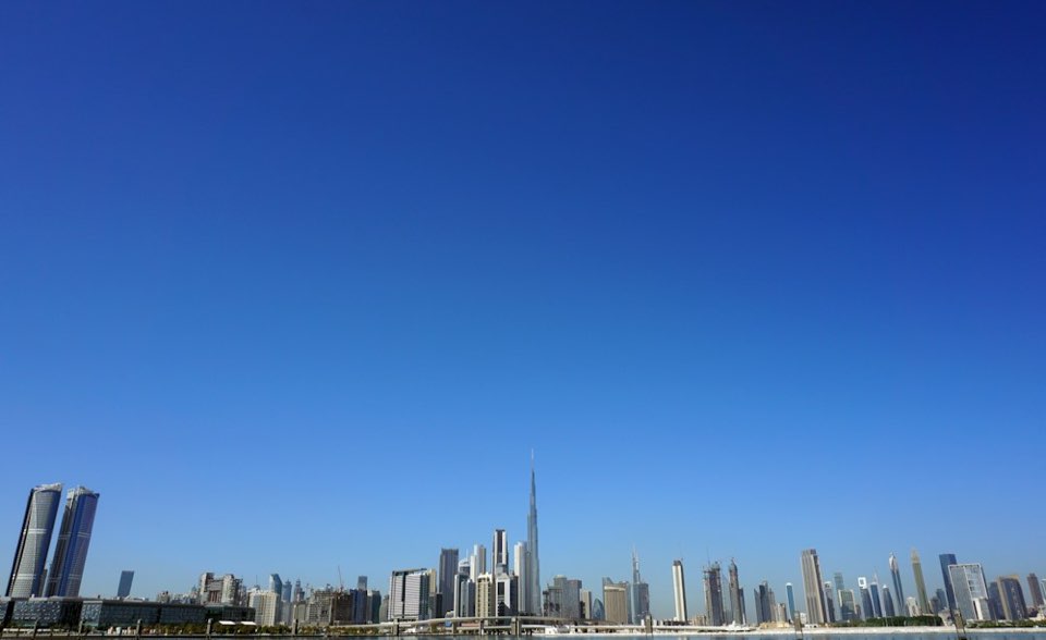 Dubai skyline and Burj Khalifa under a blue sky