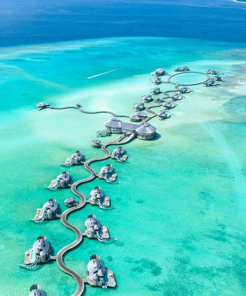 Overwater villas in a turquoise lagoon in the Maldives