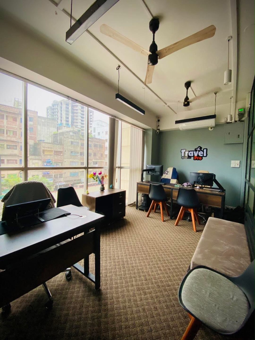 Inside the Travel Pro office: desks, computers and a seating area for customers